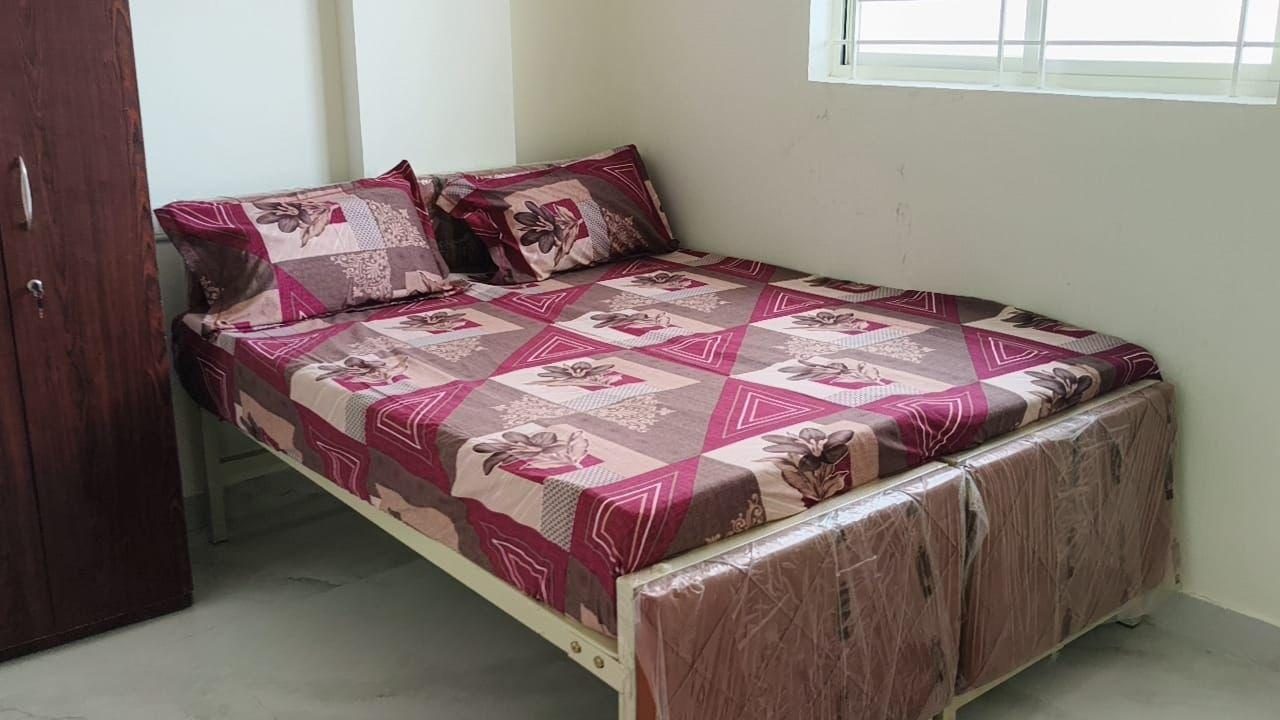 The Beehive Hostel — double bed with wardrobe