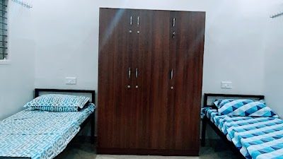 The Beehive Hostel — room wardrobe and beds